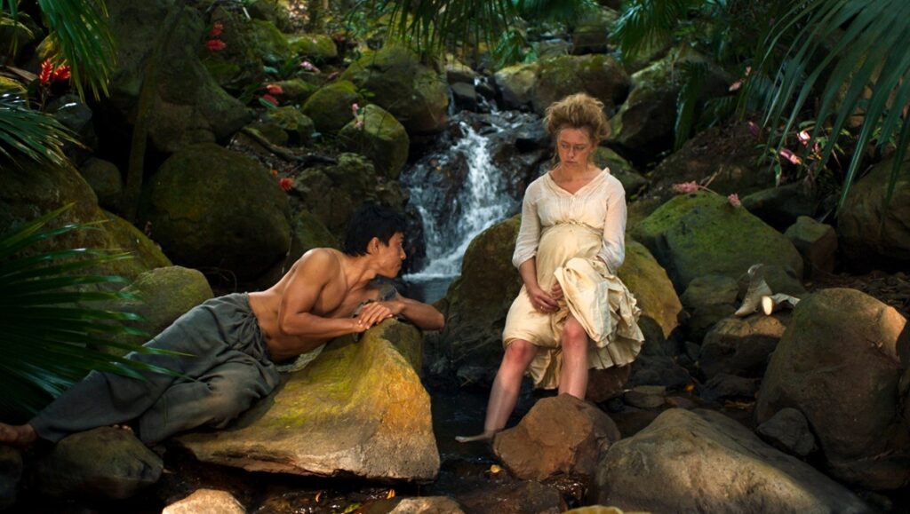 Sweet Dreams film still: Pregnant woman and man by waterfall. Ena Sendijarevic movie scene in jungle.