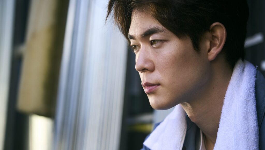 Daishi Matsunaga's Egoist movie review image. Close-up of a man looking away.