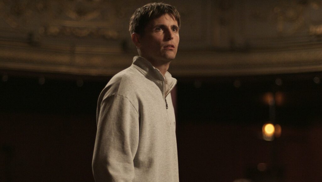 Yannick movie still. Man in a theater. Quentin Dupieux film review.