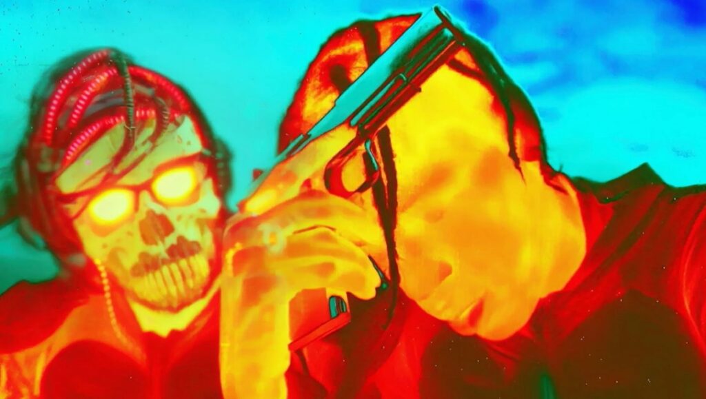 AGGRO DR1FT still: Travis Scott with a gun and a skull-faced character with glowing eyes. Harmony Korine film.