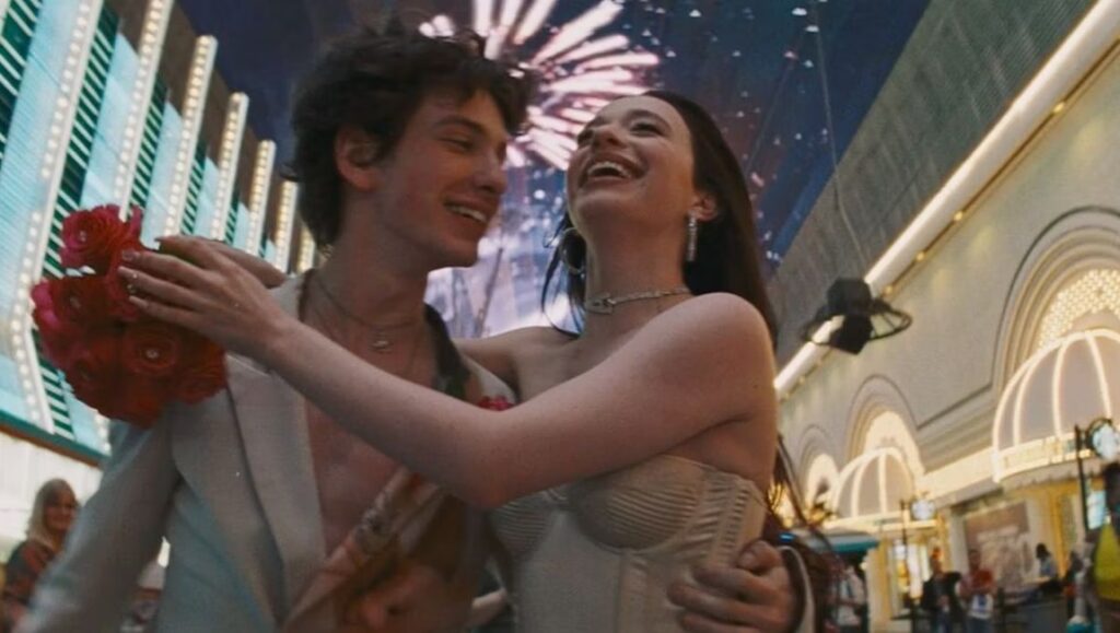 Anora (2024): A smiling couple embraces, fireworks in the background. The Sean Baker film premiered at Cannes.