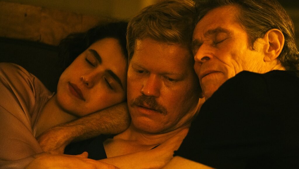 Kinds of Kindness movie still: Emma Stone, Jesse Plemons, and Willem Dafoe in a close embrace.