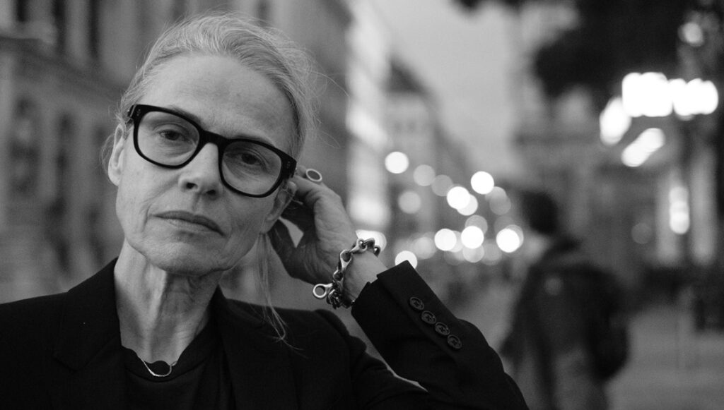 Angela Schanelec, black and white portrait. Director with glasses, discussing Complexities of Oedipus. Conversation image.
