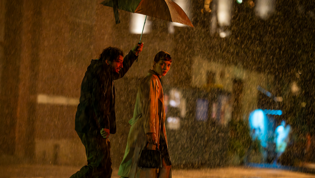 Scene from Tribeca Film Festival's Shallow Tale of a Writer: Two people under an umbrella in the rain.