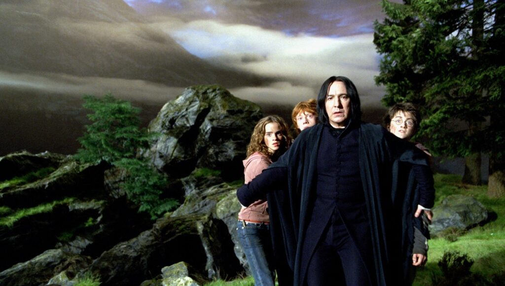 Harry Potter and the Prisoner of Azkaban scene: Snape, Hermione, Ron, and Harry in a landscape.