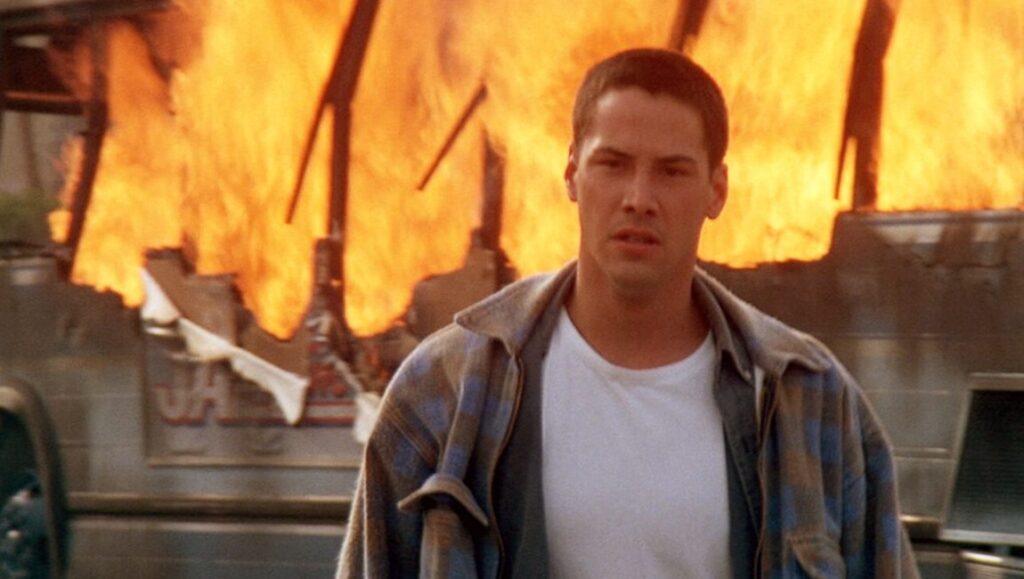 Speed — Jan de Bont Keanu Reeves in Speed (1994). Action movie scene with burning building. Jan de Bont film.