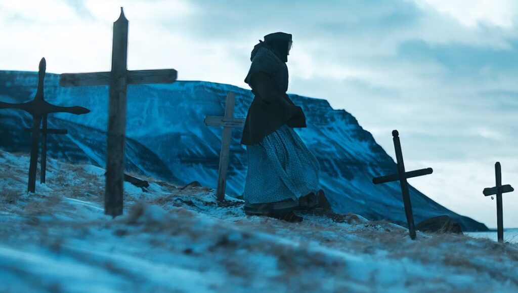 The Damned at Tribeca Film Festival: Woman stands among crosses in a snowy landscape.