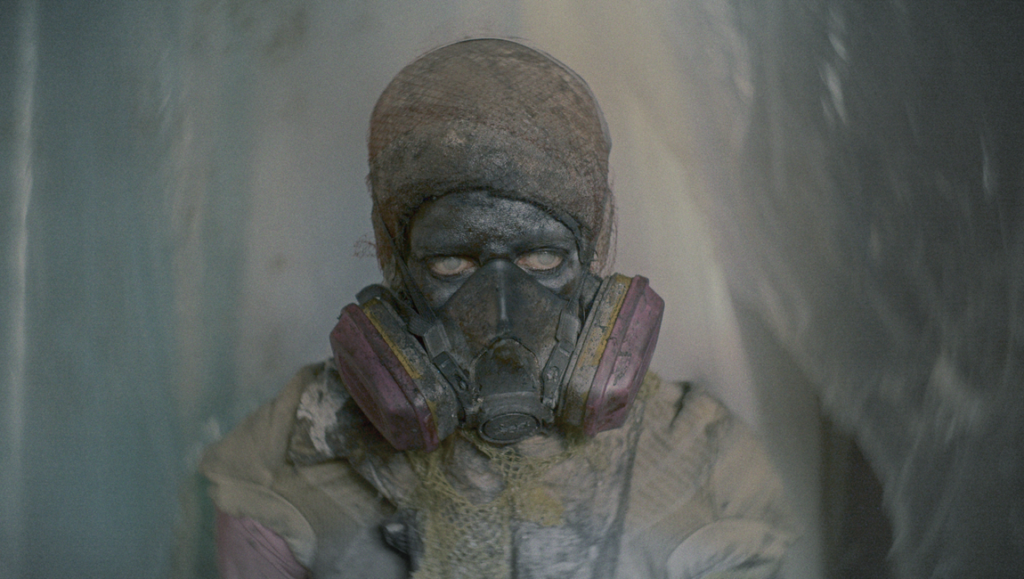 Animalia Paradoxa film still: person in hazmat suit and gas mask. Fantasia Fest 2024 review.
