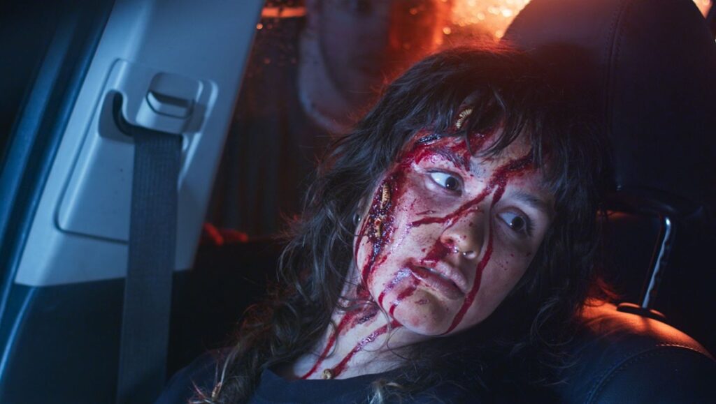 Fantasia Fest: Carnage for Christmas still. Injured woman in a car, blood on face. Horror film.