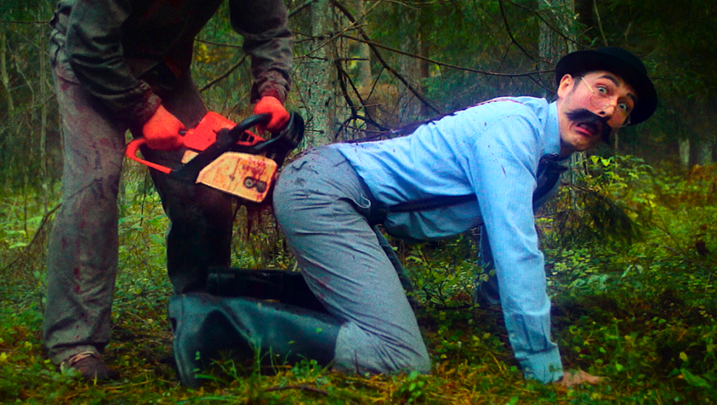Fantasia Fest: Chainsaws Were Singing. Man with chainsaw near another man in a forest. Horror movie still.