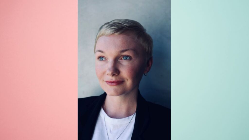 Nicole Riegel headshot. Director with short blonde hair and blue eyes. Interview with Nicole Riegel.