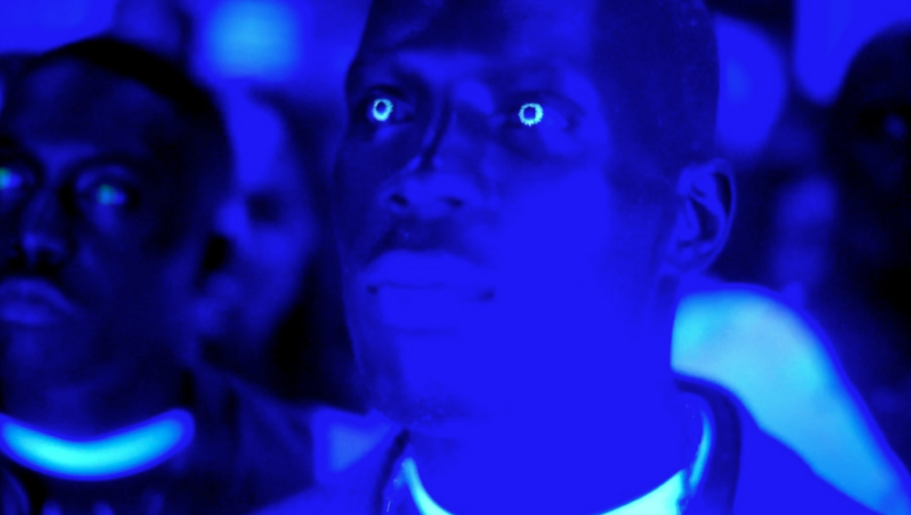 Nas in Belly by Hype Williams. Blue-lit scene with glowing eyes.
