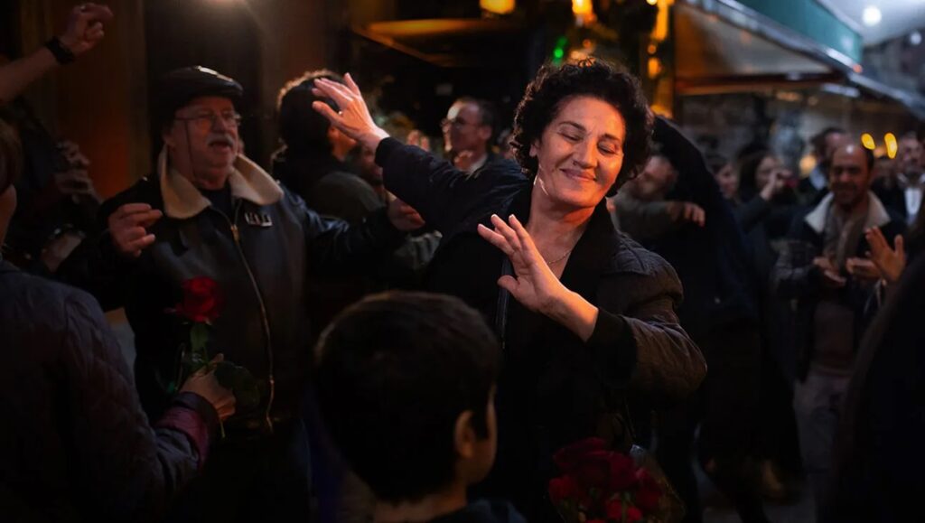 Crossing film review: Lia dances joyfully in a crowd. Levan Akin film.