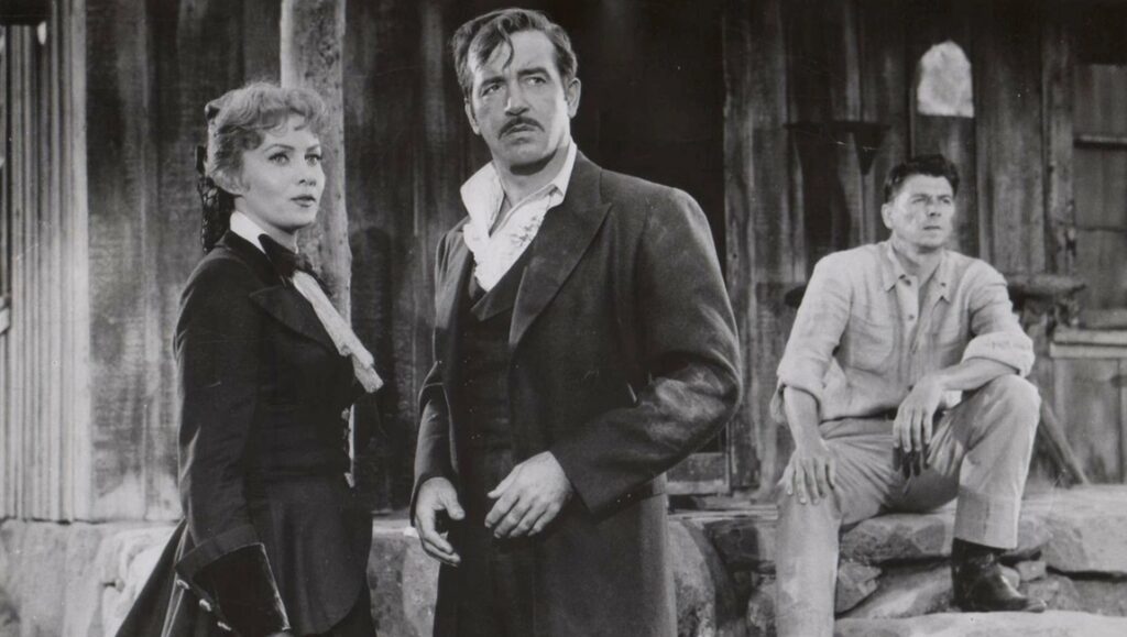 Allan Dwan's Tennessee's Partner movie still. Barbara Stanwyck, Ronald Reagan, and John Payne in a black and white western.