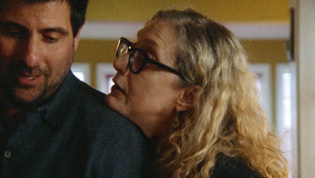 Nathan Silver interview image: Woman with glasses rests head on man's shoulder. Other People's Minds, Other People's Hearts.