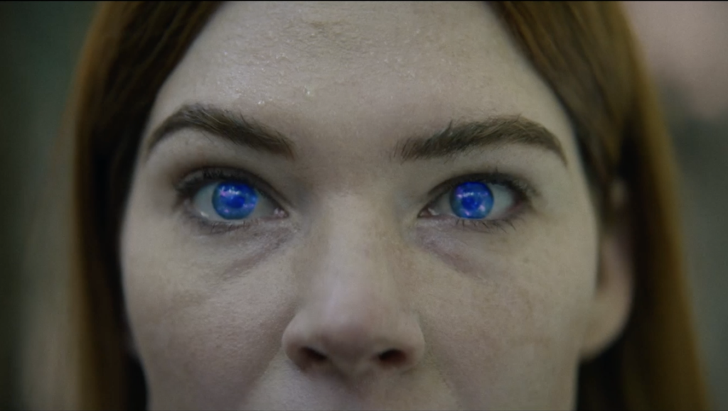 Close-up of woman's face with bright blue eyes from Consumed movie. Mitchell Altieri film review.