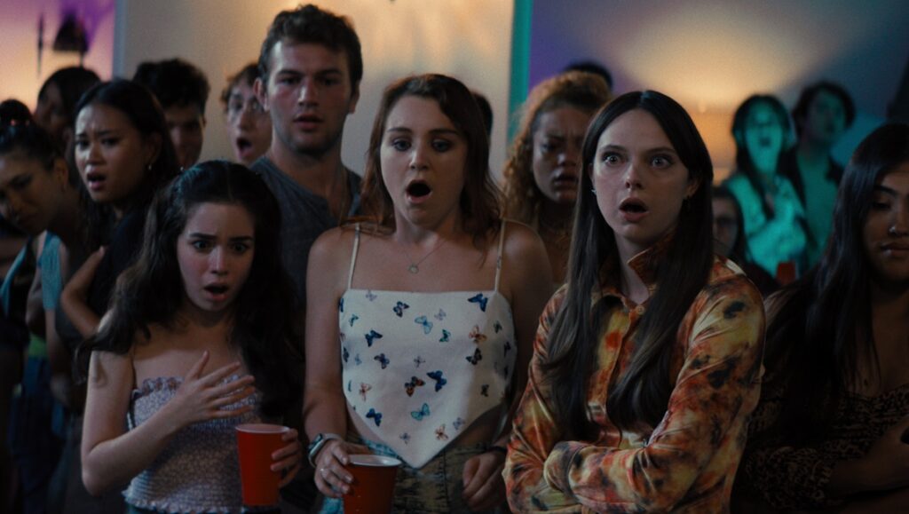 Incoming movie scene. A group of young adults looks shocked and surprised at a party. Dave Chernin, John Chernin film.