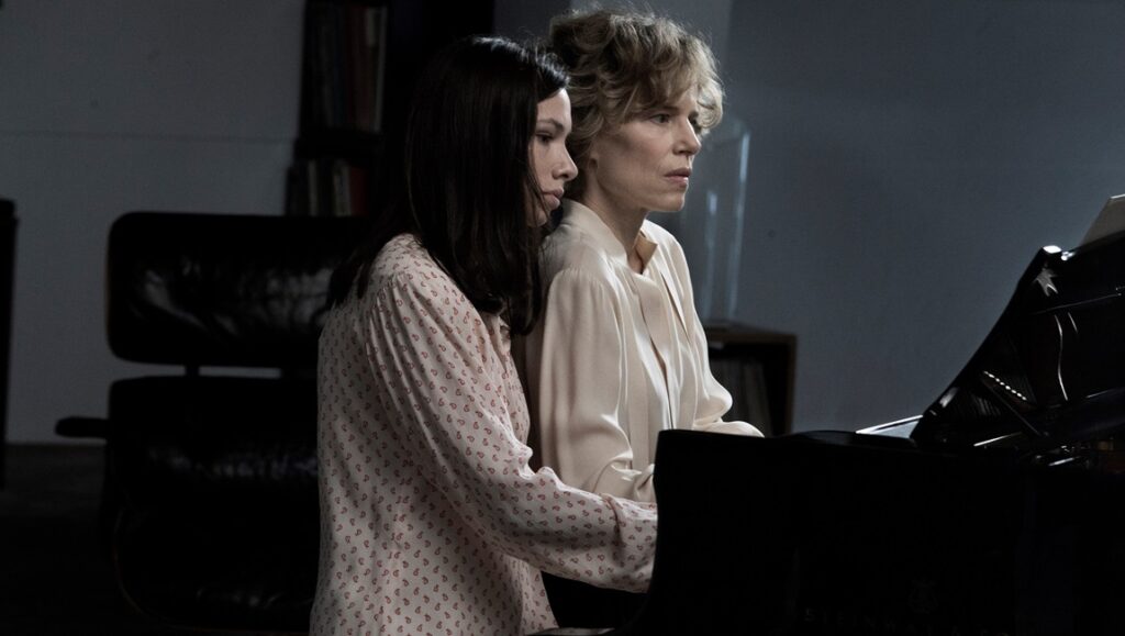 La vita accanto film still from Locarno Film Festival. Two women at a piano. Angelo Turetta.