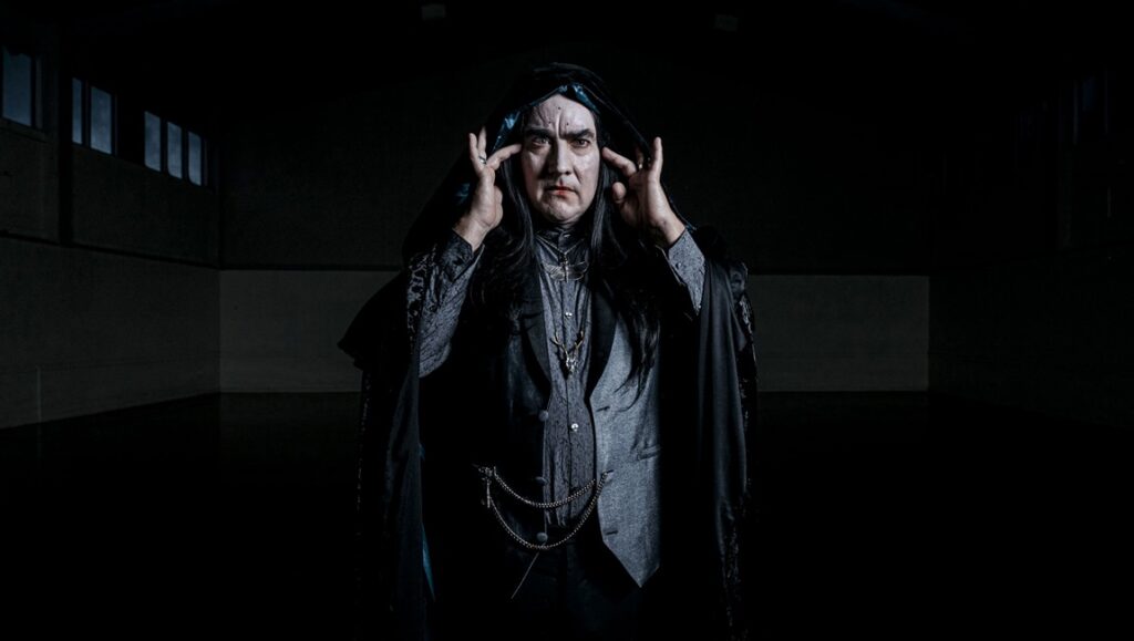 Fantasia Fest: The Paragon film still. Man in dark cloak and makeup. Horror movie.