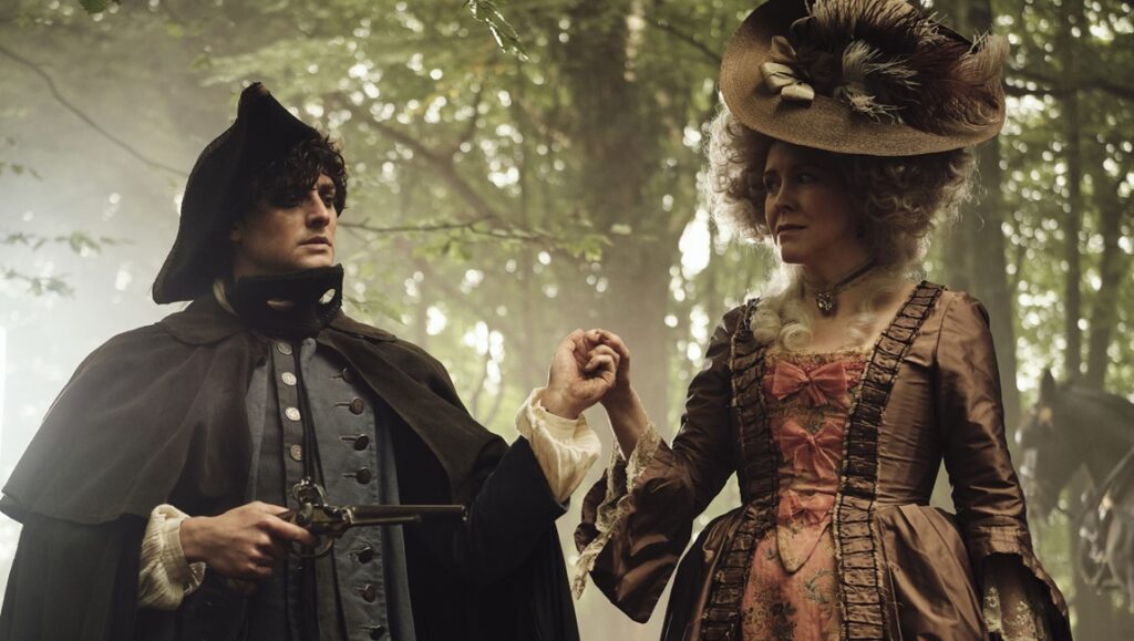 Timestalker film still. Man with pistol and woman in period dress hold hands in a forest. Fantasia Fest 2024.