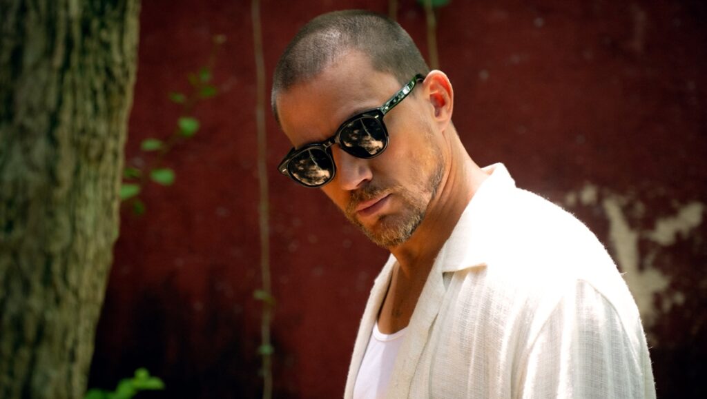 Channing Tatum in Blink Twice. Actor with sunglasses and white shirt. Zoë Kravitz film review.