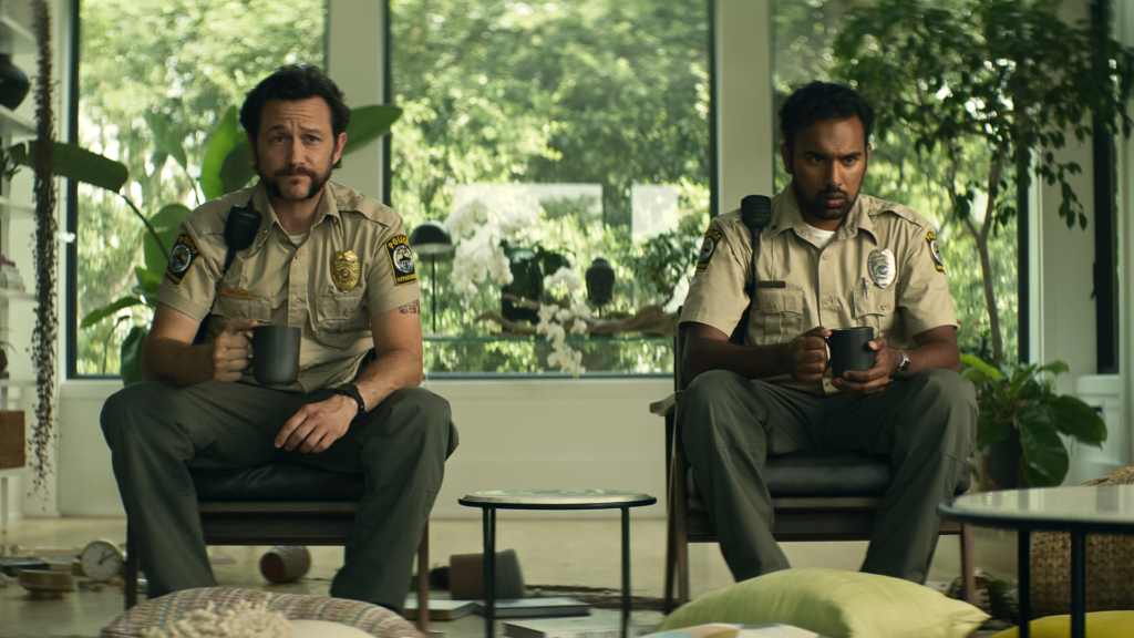 Greedy People review: Joseph Gordon-Levitt and Kal Penn as officers in a modern home.