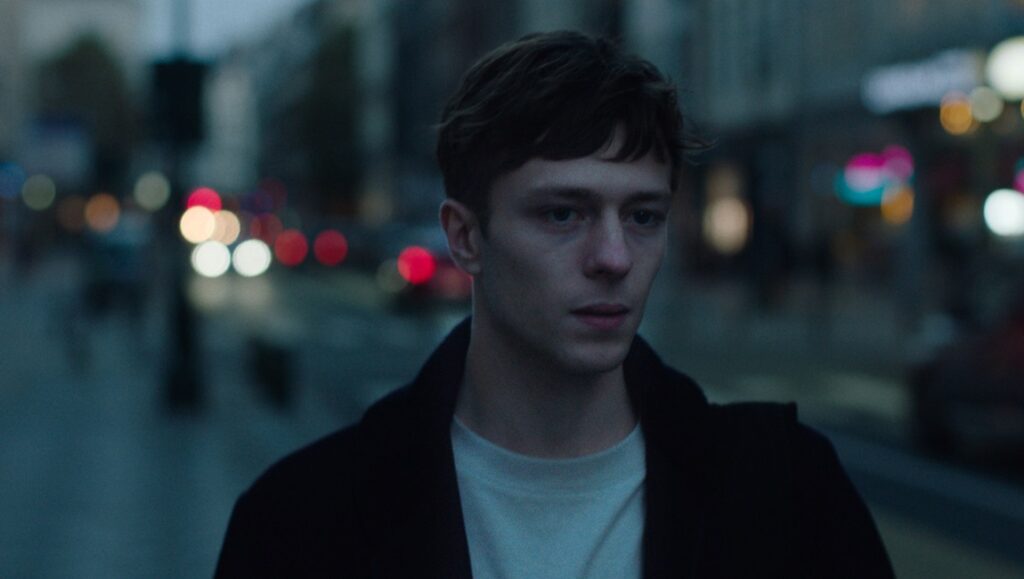 Mikko Mäkelä in Sebastian movie review. Portrait of the actor in an urban setting at night.