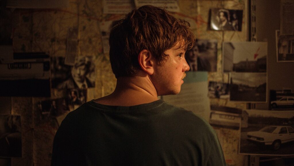 Maldoror — Fabrice Du Welz Anthony Bajon, actor in Maldoror by Fabrice Du Welz. Man in front of a wall covered with photos.