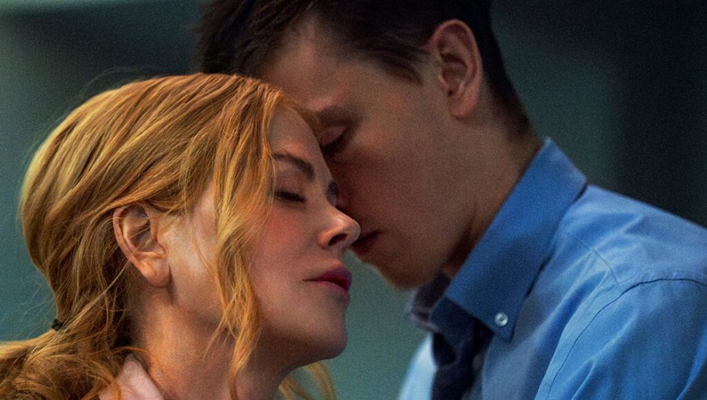 Babygirl movie still. Halina Reijn film scene: a woman and a man with their faces close together, eyes closed.