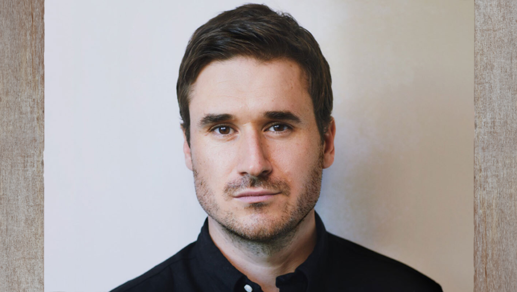 Kazik Radwanski portrait. Close-up of the director of Matt and Mara with dark hair and a black shirt.