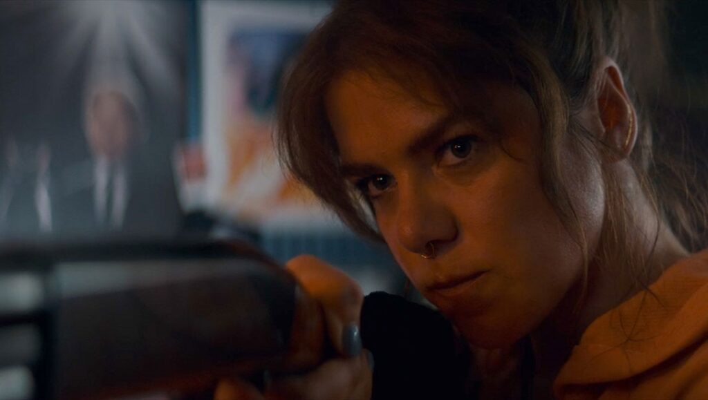 Kaniehtiio Horn in Seeds movie still. Intense close-up, holding a weapon. TIFF '24 review.