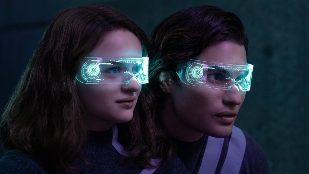Uglies movie: Two characters wearing futuristic digital glasses. Sci-fi film adaptation.