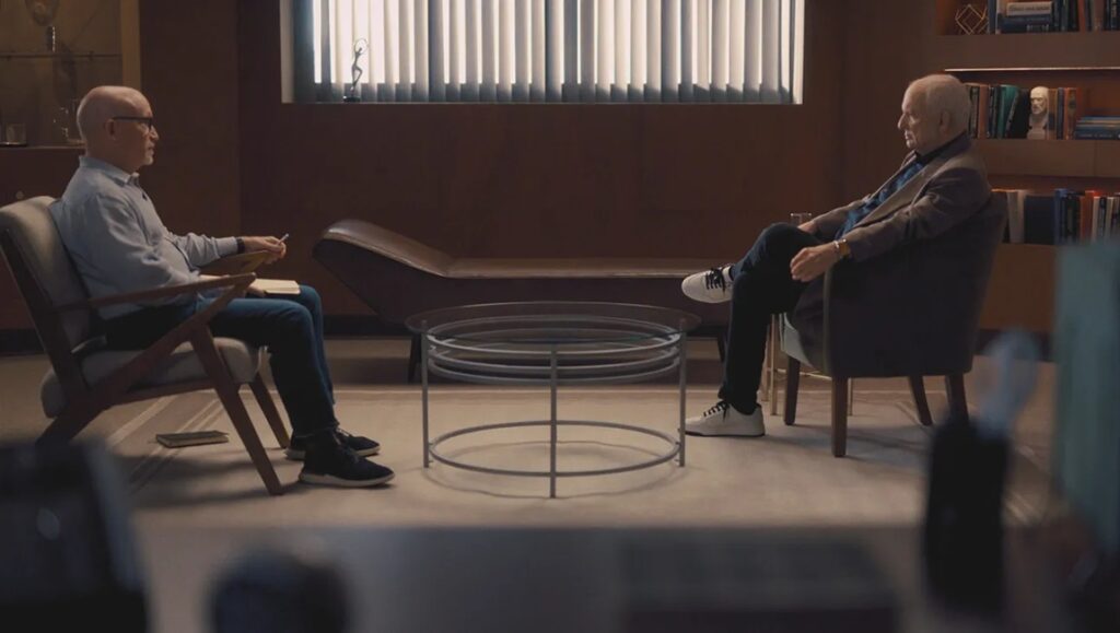 Alex Gibney interviews David Chase for Wise Guy: The Sopranos. Chase sits in a chair across from Gibney.