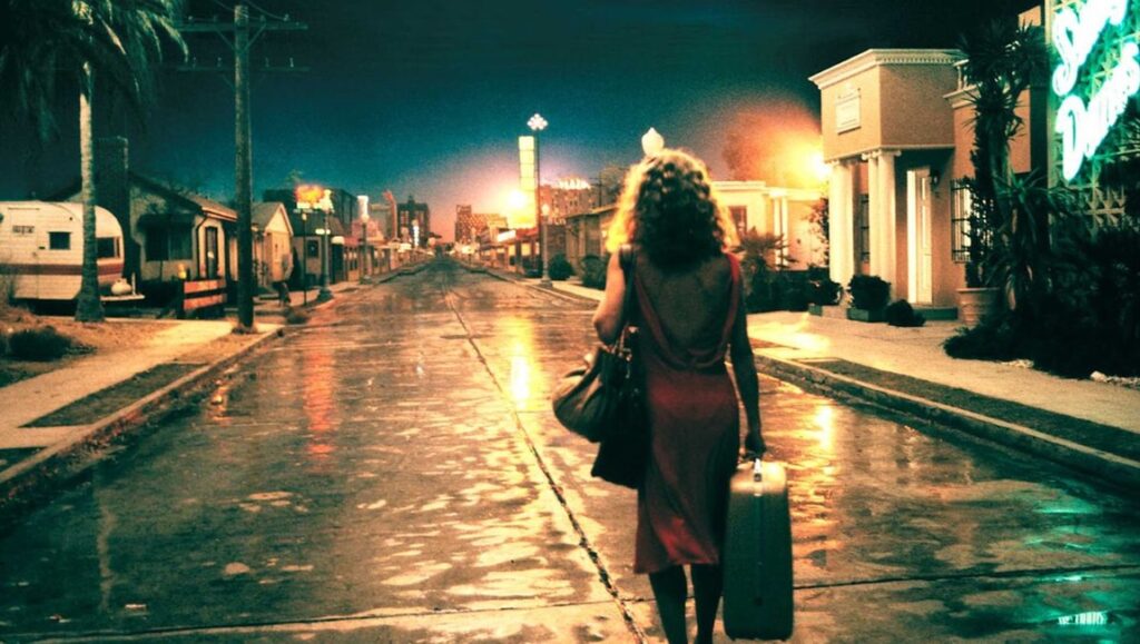 Francis Ford Coppola's One From the Heart: Woman walking down a wet street at night with a suitcase.