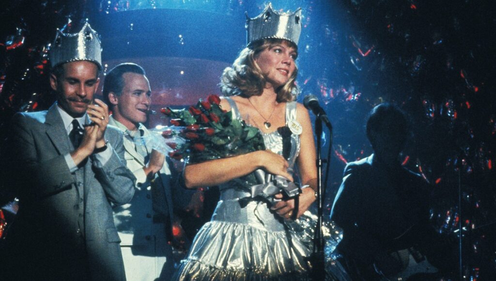 Kathleen Turner as Peggy Sue in Peggy Sue Got Married, a Francis Ford Coppola film. Prom queen with crown and roses.