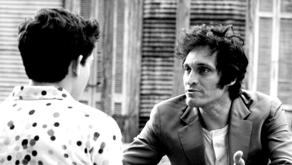 Francis Ford Coppola's Tetro film still. Black and white shot of two men in conversation.