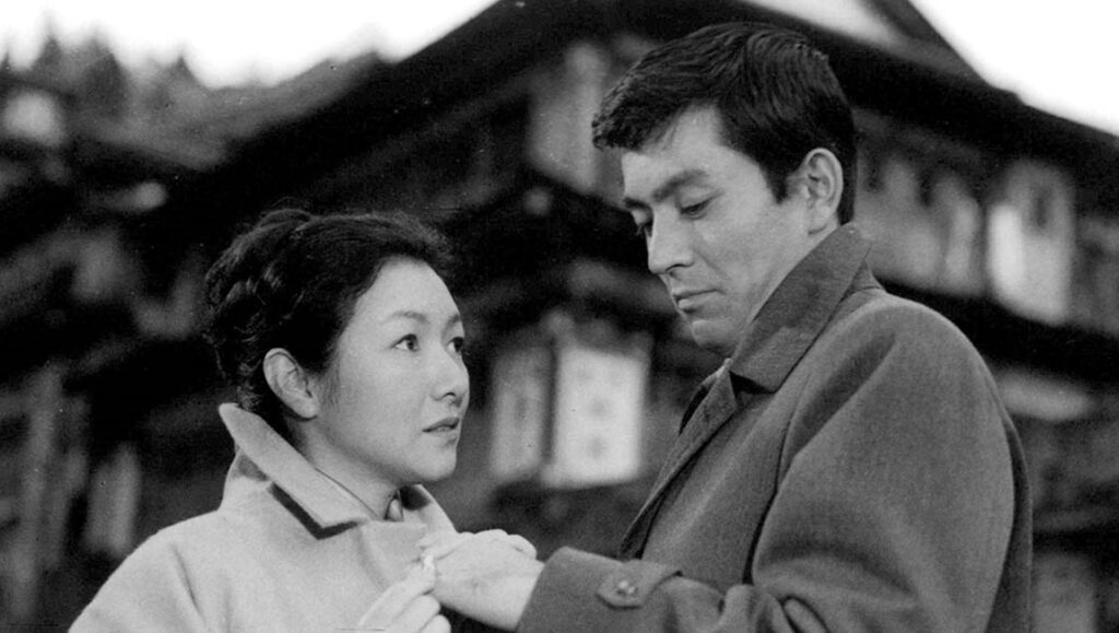 Yearning (1964) by Mikio Naruse: Black and white film still of a man and woman in coats.