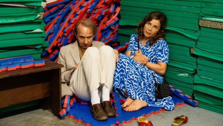 Being Blanche Houellebecq film review image. Guillaume Nicloux directs Blanche, seated beside Michel Houellebecq.