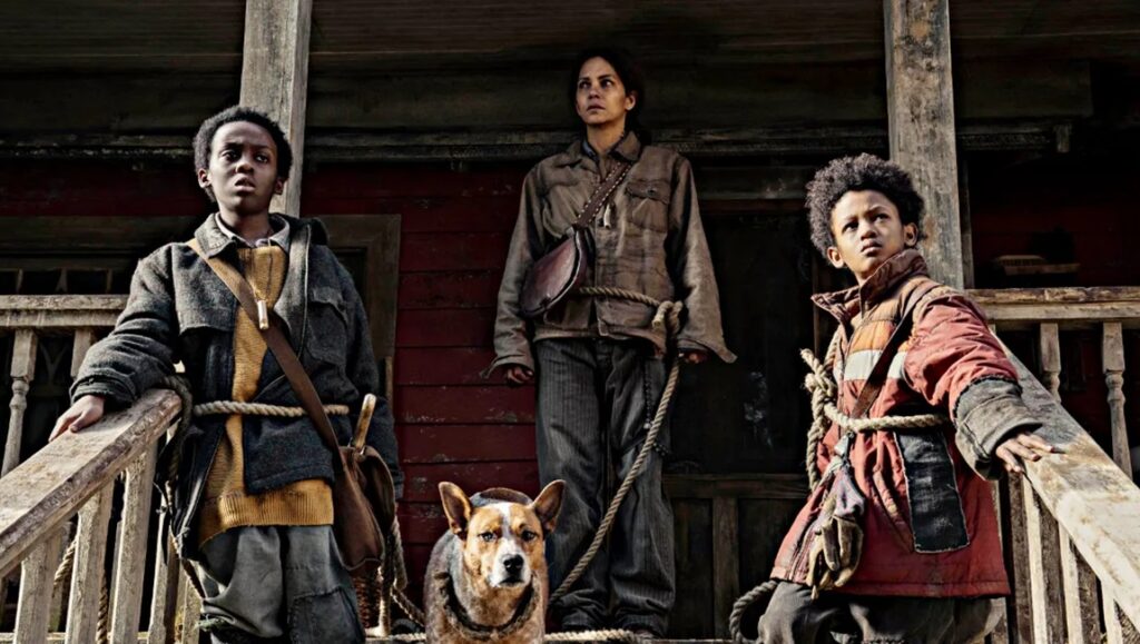 Never Let Go movie scene: A woman, two boys, and a dog stand on a porch.