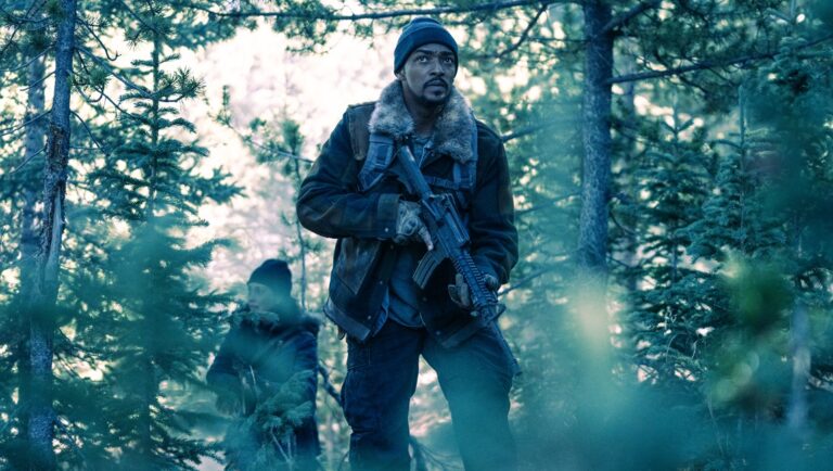 Anthony Mackie in Elevation movie review. Man with rifle in forest. George Nolfi film.