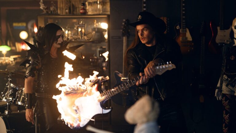 Heavier Trip movie still: Guitar on fire, two metal musicians. Finnish film review.