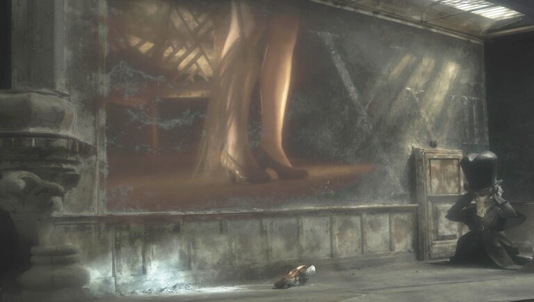 Sanatorium Under the Sign of the Hourglass still. Quay Brothers film scene with a figure kneeling before a large image of legs.