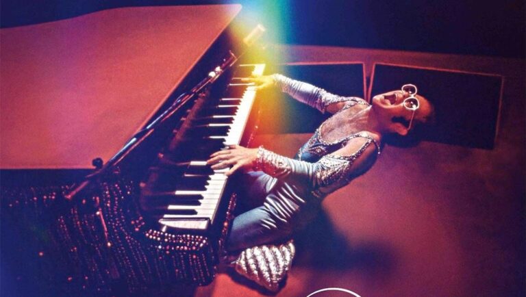 Elton John playing piano. Never Too Late review.