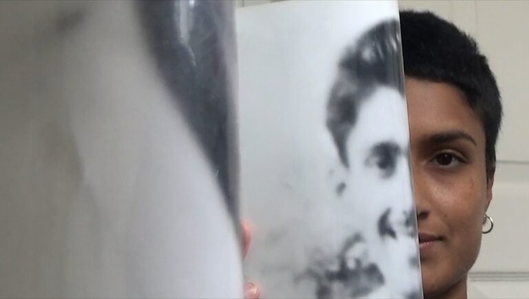 Chloe Abrahams, The Taste of Mango review. Woman holding a photo, half her face visible.