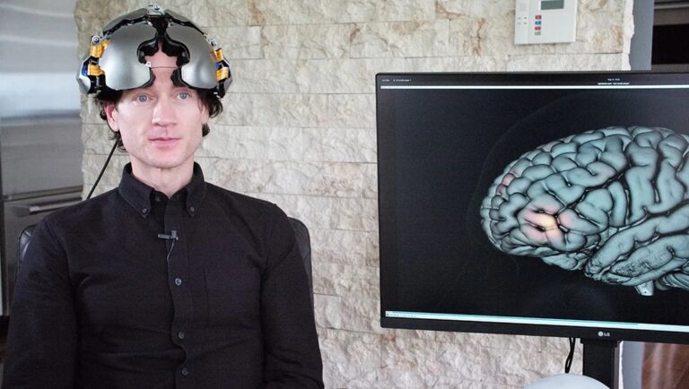 Werner Herzog's Theater of Thought review. Man with brain scan helmet, brain activity monitor. Neuroscience concept.