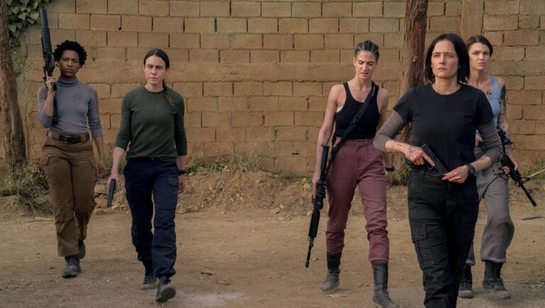 Dirty Angels movie review: All-female mercenary team armed with rifles and pistols walk in formation.