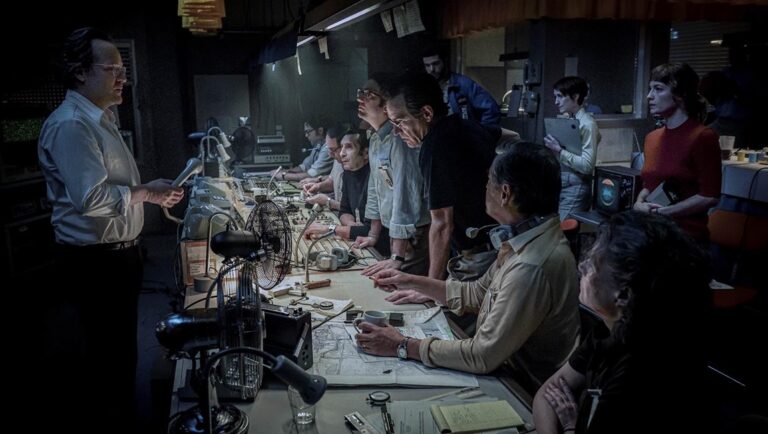 September 5 review: Control room scene with engineers and technicians monitoring equipment, intense focus.