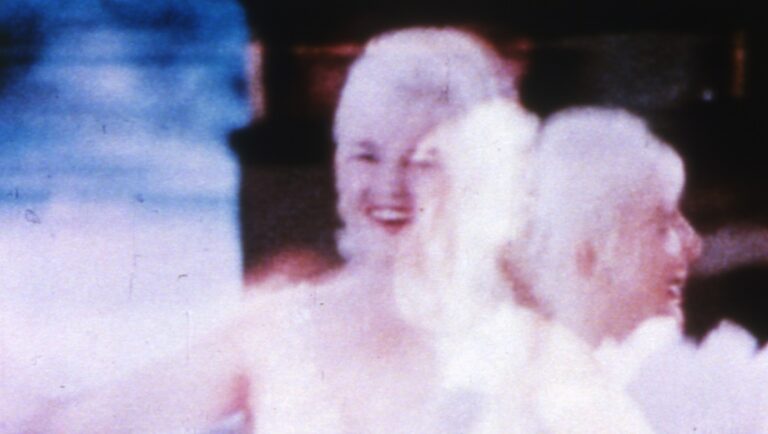Throbs film still by Fred Worden. Experimental film art featuring a smiling woman.