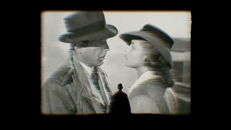 Grand Illusion movie scene. Man and woman in hats, close together. Classic film still.