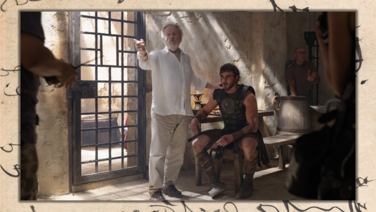 Ridley Scott directs a scene with a gladiator actor. Behind-the-scenes shot of the film production. Aidan Monaghan is the credited photographer.